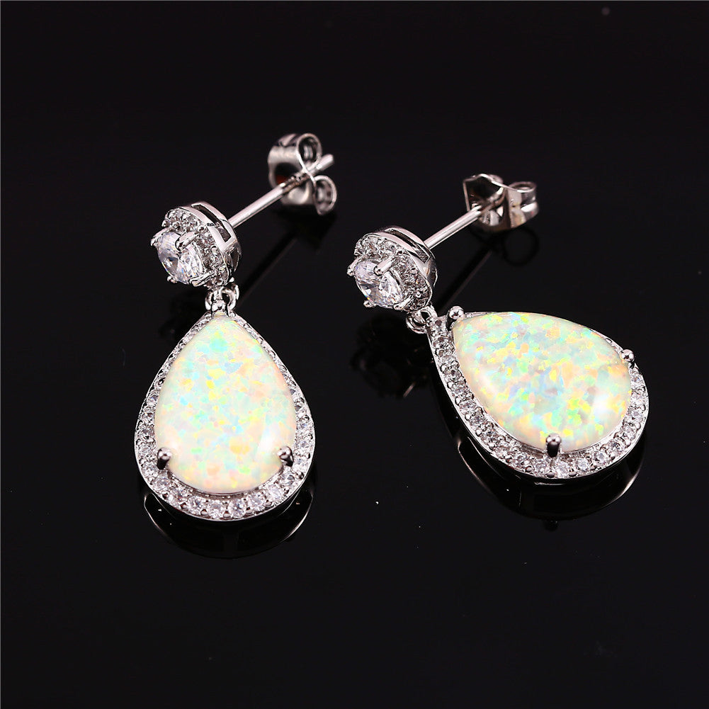 "Elevate your style with these Platinum Opal Water Drop Earrings. The elegant water drop design adds a touch of wildness and the opal centerpiece exudes a sophisticated charm. Perfect for any occasion, these earrings will make you stand out and feel confident"