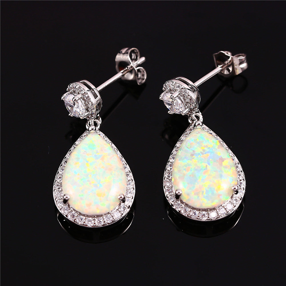 "Elevate your style with these Platinum Opal Water Drop Earrings. The elegant water drop design adds a touch of wildness and the opal centerpiece exudes a sophisticated charm. Perfect for any occasion, these earrings will make you stand out and feel confident"