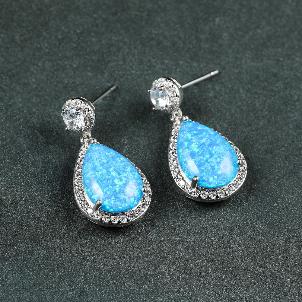 "Elevate your style with these Platinum Opal Water Drop Earrings. The elegant water drop design adds a touch of wildness and the opal centerpiece exudes a sophisticated charm. Perfect for any occasion, these earrings will make you stand out and feel confident"