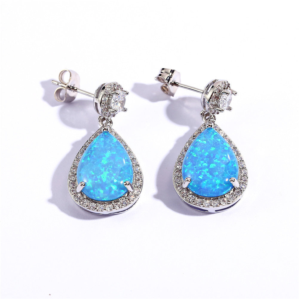 "Elevate your style with these Platinum Opal Water Drop Earrings. The elegant water drop design adds a touch of wildness and the opal centerpiece exudes a sophisticated charm. Perfect for any occasion, these earrings will make you stand out and feel confident"