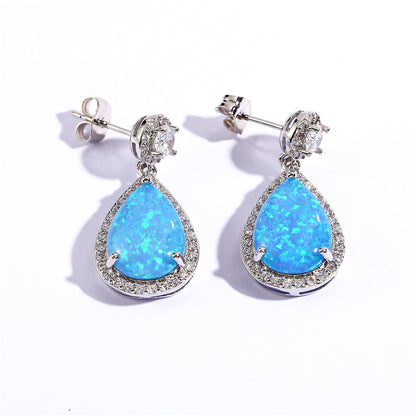 "Elevate your style with these Platinum Opal Water Drop Earrings. The elegant water drop design adds a touch of wildness and the opal centerpiece exudes a sophisticated charm. Perfect for any occasion, these earrings will make you stand out and feel confident"