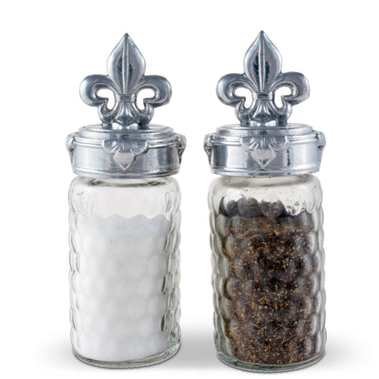 "Fleur-De-Lis Salt and Pepper Set"Spice up your meals with the elegant Fleur-De-Lis Salt and Pepper Set! Featuring the iconic French symbol, this set adds a touch of charm to any dining experience. Its functionality and design make it a must-have for any kitchen or dining room. Add a touch of sophistication to your meals with this unique set"